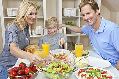 family-eating-healthy-food-salad-dining-table-23740634